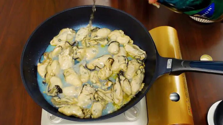 Add a little bit of white wine and cook the oysters