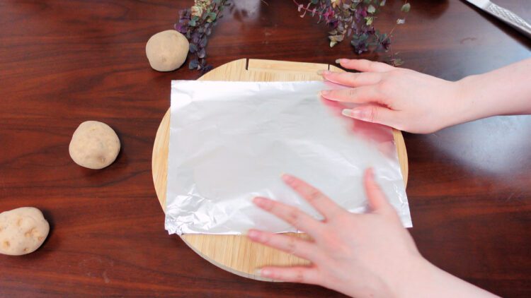 place one or two sheets of aluminum foil on the cutting board