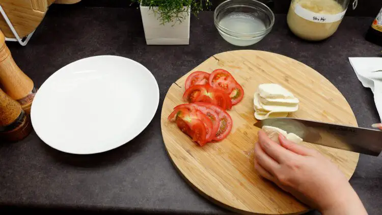 slice up tomato and mozzarella cheese into bite-size pieces