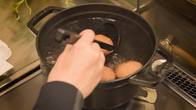 Add refrigerated, cold eggs into the boiling water with a ladle