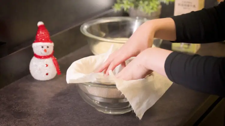 Lay a cloth or basket-style coffee filter over the strainer