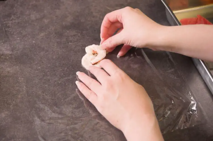 lay one or two pieces of shrimp on a plastic wrap