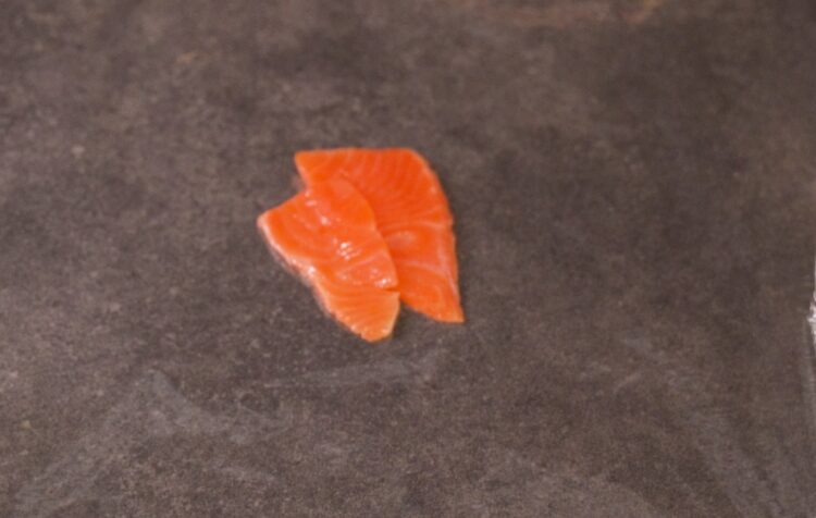 place salmon slices on a plastic wrap