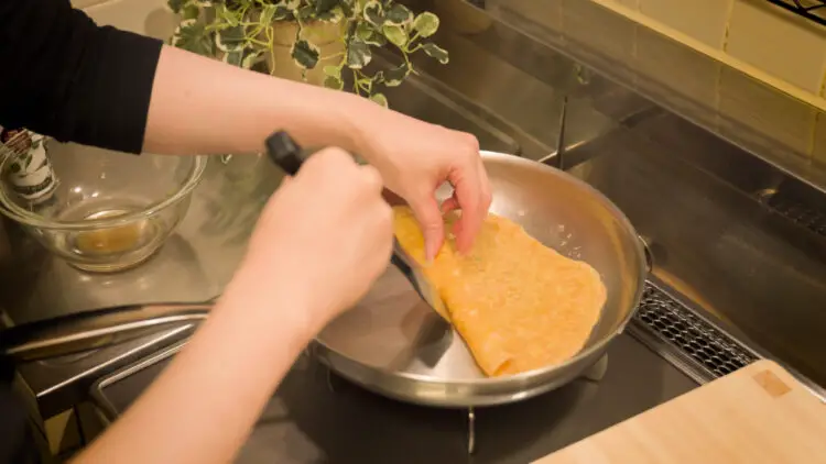 roll up the crepe on the pan using a spatula