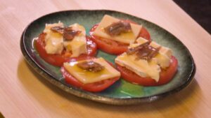placing anchovy fillet on the cheeses