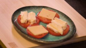 placing cheeses on tomato slices