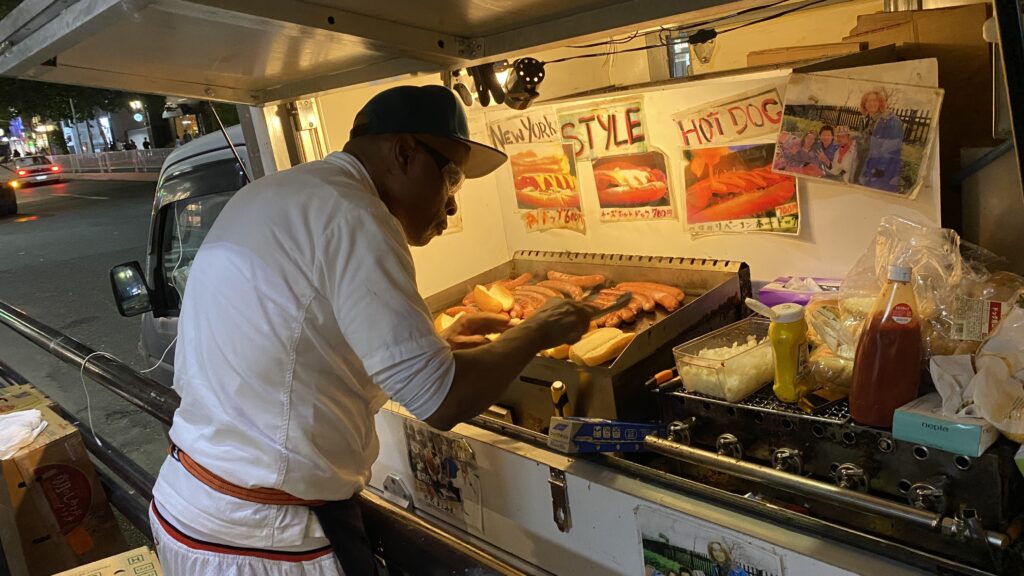Kajuru Kenny cooking hot dogs