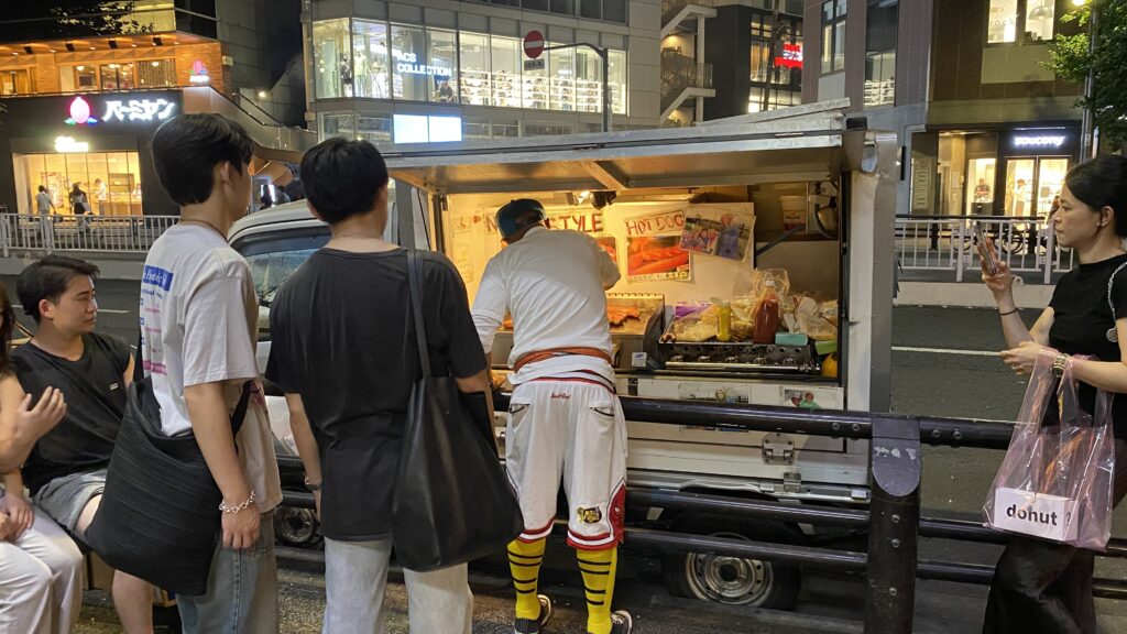 Kajuru Kenny cooking while customers are watching