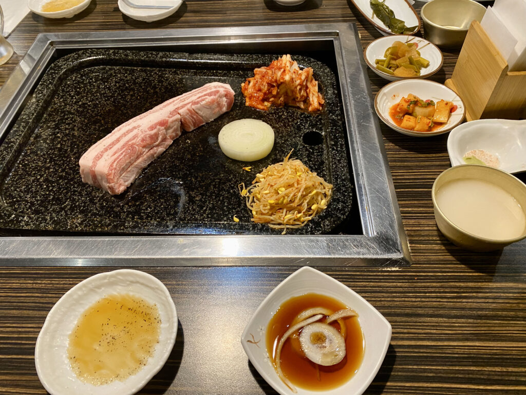 cooking plate and side dishes at Yaki Banzai