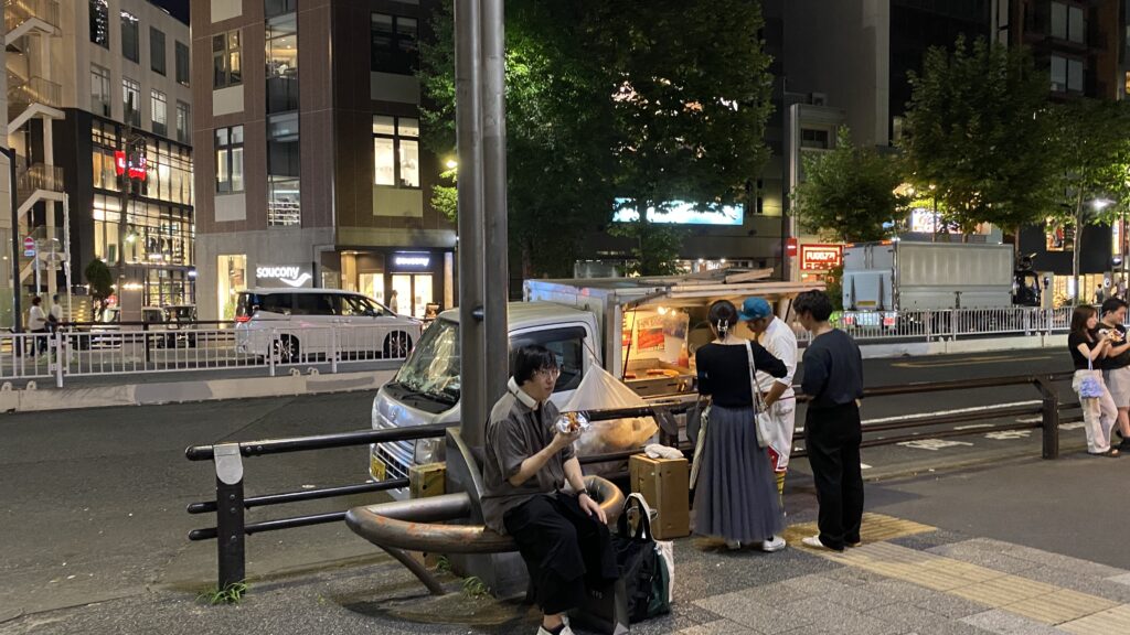 customers eating hot dogs near the truck