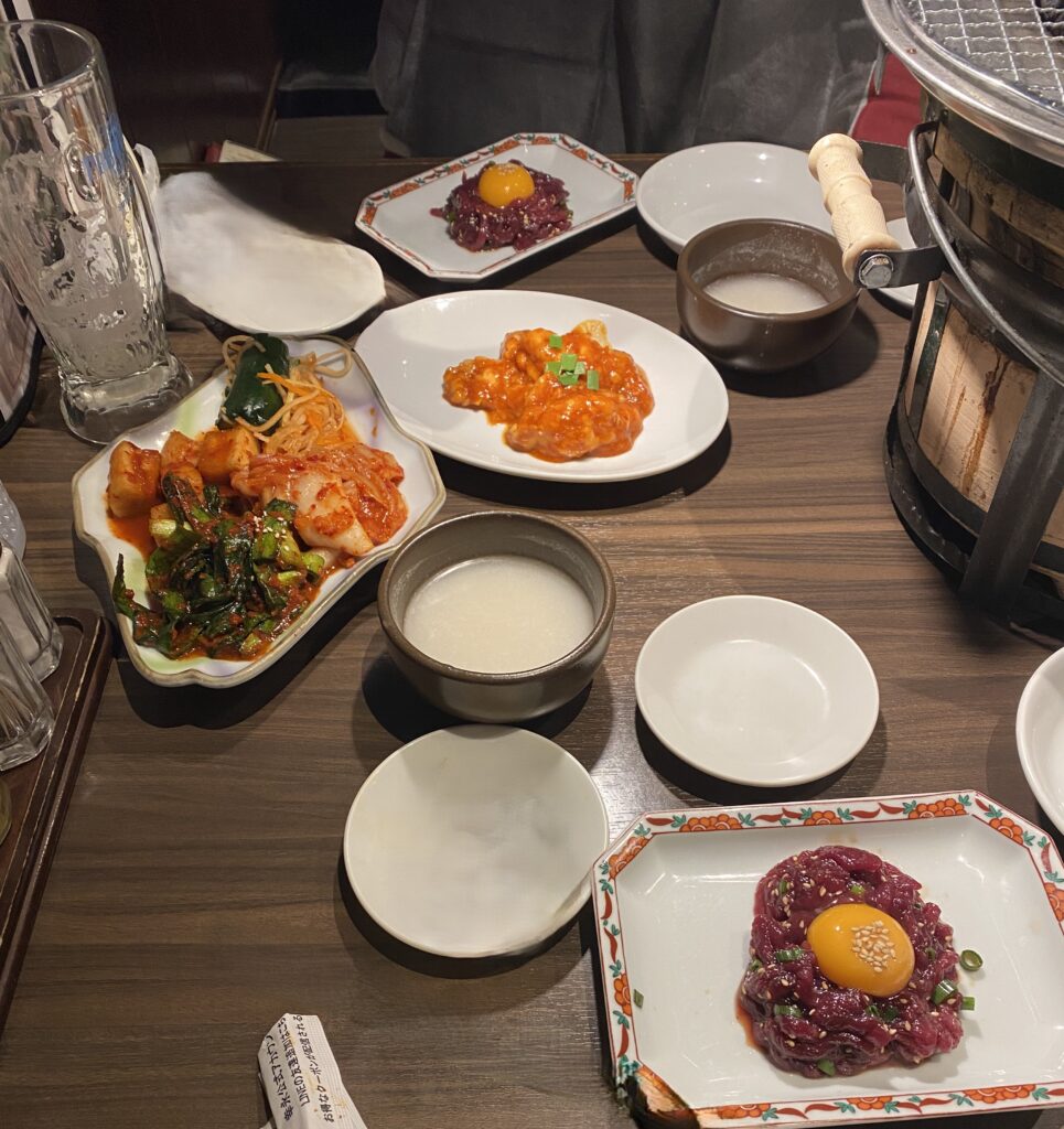 kimchi assortment horse yukhoe and horumon at Koei Shinjuku Honten